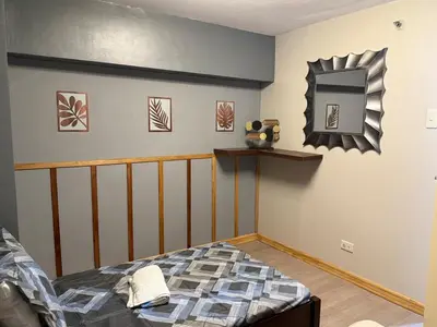 a bedroom with a bed and a mirror on the wall at 2 bedroom loft type near Rockwell in Manila