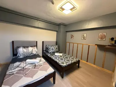 a room with two beds in a room at 2 bedroom loft type with 2 baths Near Ortigas Cbd in Manila