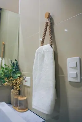 a towel hanging on a wall in a bathroom at Upscale Stylish Suite Near BGC and View of Venice Grand Canal Mall in Manila