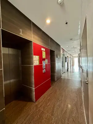 a hallway in a building with a red wall at NIJECRIFIL Condotel in Manila