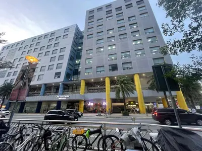 a large building with bikes parked in front of it at cozy 1 bedroom retreat Walk to Moa in Manila