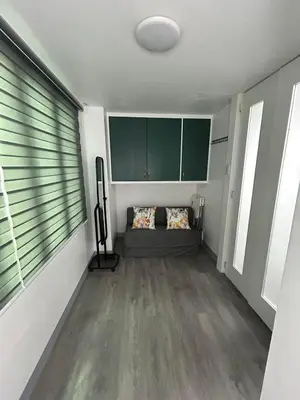 a room with a bed and a large window at Simple but cozy, feel at home in Manila