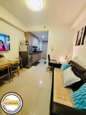 a living room with a couch and a table at EMZ Shore Staycation 38 in Manila