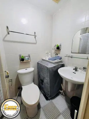 a bathroom with a toilet and a sink at EMZ JAZZ Staycation in Manila