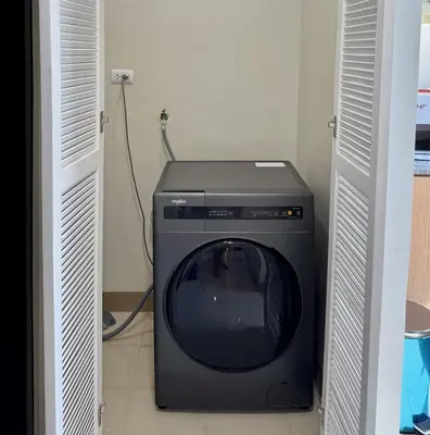 a television and a washing machine in a room at Panoramic Seaview near Airport Facing the Bay 14H in Manila