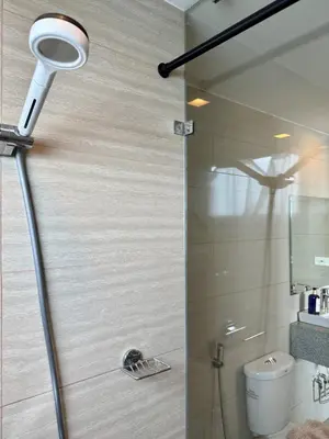 a bathroom with a shower with a light on it at Panoramic Seaview near Airport Facing the Bay 14H in Manila