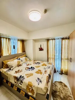 a bedroom with a large bed in a room at Avida Towers San Lazaro in Manila