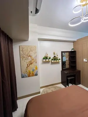 a bedroom with a bed and a mirror at Chino Roces Makati - No Parking - Red Residences in Manila
