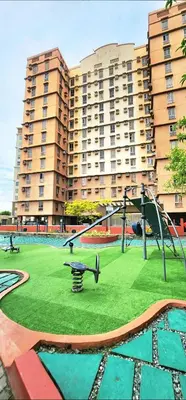 a playground in front of a large apartment building at Avida Towers Sucat in Manila