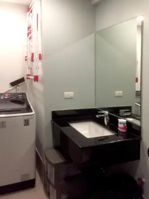 a bathroom with a sink and a large mirror at Two Maridien 41stFlr Studio -Minimalist Functional in Manila
