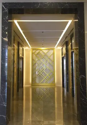 a hallway in a hotel with a gold elevator lobby at Two Maridien 41stFlr Studio -Minimalist Functional in Manila