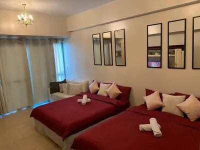 a bedroom with two beds and a couch at 81NB Cozy Studio -City View, 2 Queen Beds, NAIA T3 in Manila