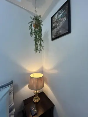 a lamp on a table in a room at Marvinn's by LVH - 150 Newport Boulevard in Manila