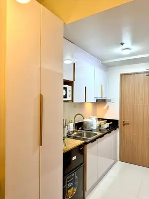 a kitchen with white cabinets and a sink at The Haven Suite Shore3 Residences T2 in Manila
