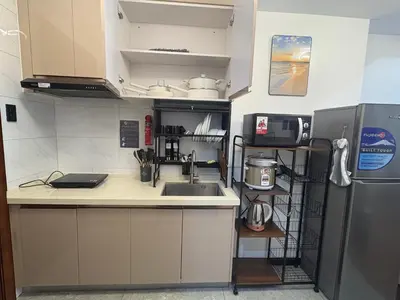 a small kitchen with a sink and a refrigerator at Sybay suites near okada MOA airport NAIA COD Manila MSV1806H in Manila