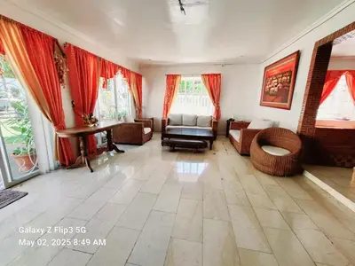 a large living room with red curtains and a couch at Majesty Suites in Manila