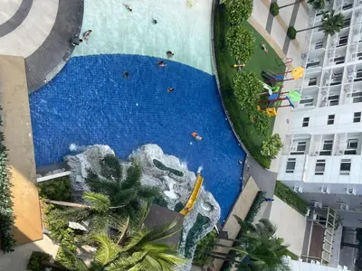 an aerial view of a pool with a water slide at Cozy Room in Modern Paraaque Condo with 2 Bedrooms in Manila