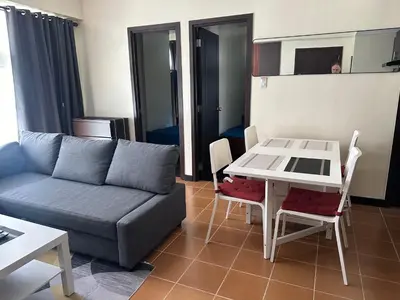 a living room with a couch and a table at 2BR Condo in Makati- Good for 6! in Manila
