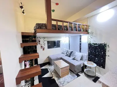 a living room with a loft bed and a couch at Loft life Staycation in Manila