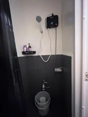a bathroom with a toilet with a camera on the wall at Loft life Staycation in Manila