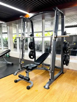 a gym with two treadmills and a chair at Grand Marina Residences in Manila