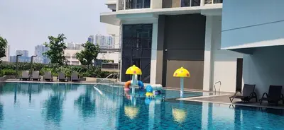 a swimming pool with a fountain in the middle of a building at 29c BGC Cozy Suite Steps Away From Major Malls with Paid Parking and Gym with Fast Wi-fi in Manila