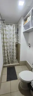 a bathroom with a toilet and a shower curtain at Colin's Suite - Hope Residences, Trece Martires in Trece Martires