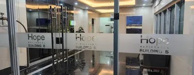 a store with signs on the doors of a building at Colin's Suite - Hope Residences, Trece Martires in Trece Martires