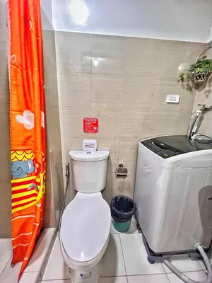 a small bathroom with a toilet and a sink at Shore Residence hosted by Nara Homes in Manila