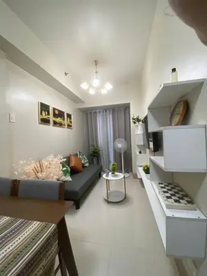 a living room with a couch and a table at The Residence Suite in Manila