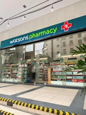 a store with a pharmacy sign in the front of it at Kai cabins NAIA 3 walking distance Newport City Pasay in Manila