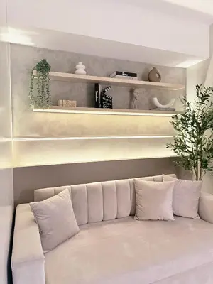 a white couch in a living room with shelves at Kasara Urban Residences in Pasig City - Solmera Cove in Manila