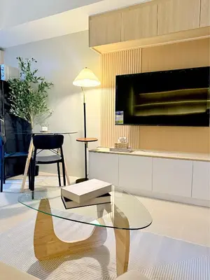a living room with a glass table and a couch at Kasara Urban Residences in Pasig City - Solmera Cove in Manila