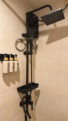 a shower head and a mirror on a wall at Kai cabins SELF CHECK IN NEAR NAIA 1 & 2 in Manila