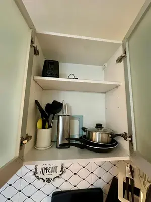 a kitchen shelf with a pot and pans on it at Stay at Downtown Suite 2 in BGC, Taguig City in Manila