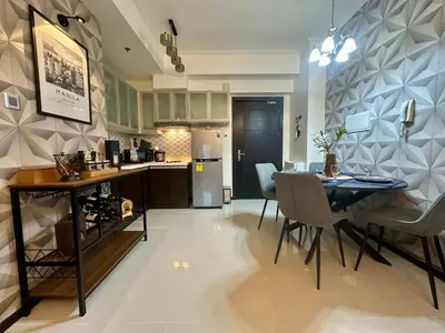 a kitchen and dining room with a table and chairs at Stay at Downtown Suite 2 in BGC, Taguig City in Manila
