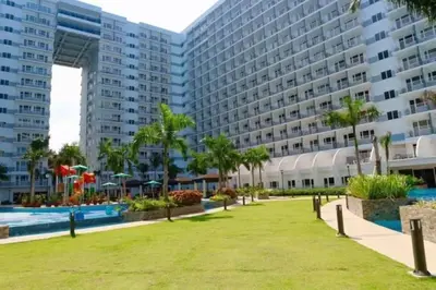 a park in front of a large building at MOA Staycation - Shell Condo in Manila