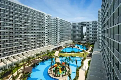 an aerial view of a resort pool with buildings at MOA Staycation - Shell Condo in Manila