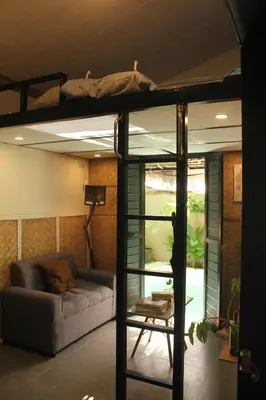 a living room with a bunk bed and a couch at Kamia Tiny Rest House in Sampong