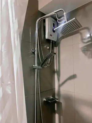 a shower head on a wall in a bathroom at Makati Stay Ph in Manila