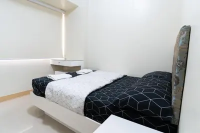 a bedroom with a bed in a white room at Solemare Parksuites - Condo In Parañaque Near MOA ARENA, SMX CONVENTION CENTER AND DFA MAIN OFFICE in Manila