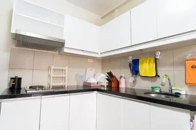 a kitchen with white cabinets and a sink at Solemare Parksuites - Condo In Parañaque Near MOA ARENA, SMX CONVENTION CENTER AND DFA MAIN OFFICE in Manila