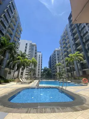 a large swimming pool with palm trees and buildings at Bekipay Suite at Two Palm tree across NAIA 3 in Manila