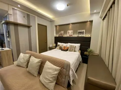 a bedroom with a bed and a couch at Bekipay Suite at Two Palm tree across NAIA 3 in Manila