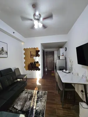 a living room with a couch and a table at The Air Residences Makati in Manila