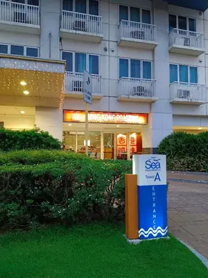 a large building with a sign in front of it at Sea residences Christine prime in Manila
