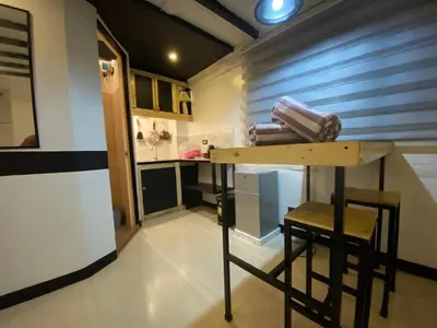 a kitchen with a counter and a stool in a room at Adorable - 2A, Chill Room in Manila