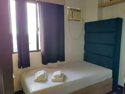 a bedroom with a bed with towels on it at Apartment in Rhapsody 2BR in Manila