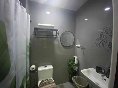 a small bathroom with a toilet and a sink at SOLACE by Athena at Air Residences Makati in Manila