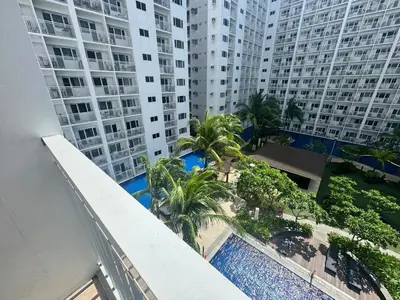 an overhead view of a swimming pool in front of tall buildings at Shore Residences Banana Room with 2 Beds Good for 4 Guests Pool View Room 622 by Prime Stay in Manila